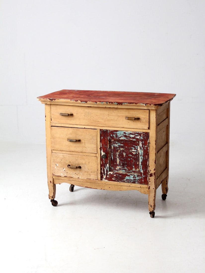 Rustic Antique Primitive Cabinet with 3 Shelves and Casters: Rustic Antique Primitive Cabinet with 3 Shelves and Casters This antique primitive cabinet showcases rustic charm with its weathered paint finish and original hardware. The spacious interior includes