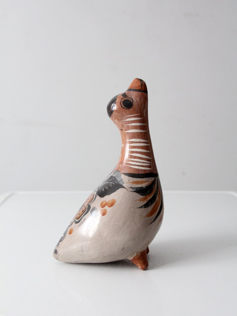 Earthenware Tonala Bird Sculpture with Floral Folk Art Motifs: Earthenware Tonala Bird Sculpture with Floral Folk Art Motifs This vintage Tonala bird figurine showcases traditional Mexican folk art pottery, featuring softly muted earthen tones and detailed with f