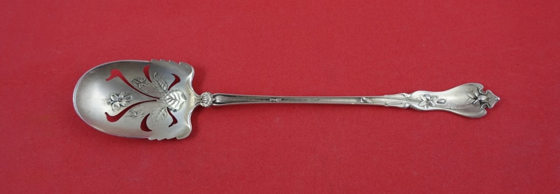 Whiting Violet Sterling Silver Olive Spoon Pierced Flowers 6": Whiting Violet Sterling Silver Olive Spoon Pierced Flowers 6" This exquisite serving spoon is part of the 'Violet' pattern by Whiting, crafted from sterling silver. The spoon features a beautifully pi