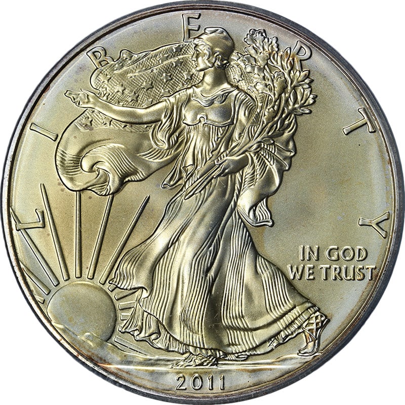 PCGS MS70 2011-S Silver Eagle Dollar John Mercanti Signed Toned Coin: PCGS MS70 2011-S Silver Eagle Dollar John Mercanti Signed Toned Coin This 2011-S Silver American Eagle $1 coin is graded PCGS MS70 and features the John Mercanti signature. Made of 0.999 fine silver,