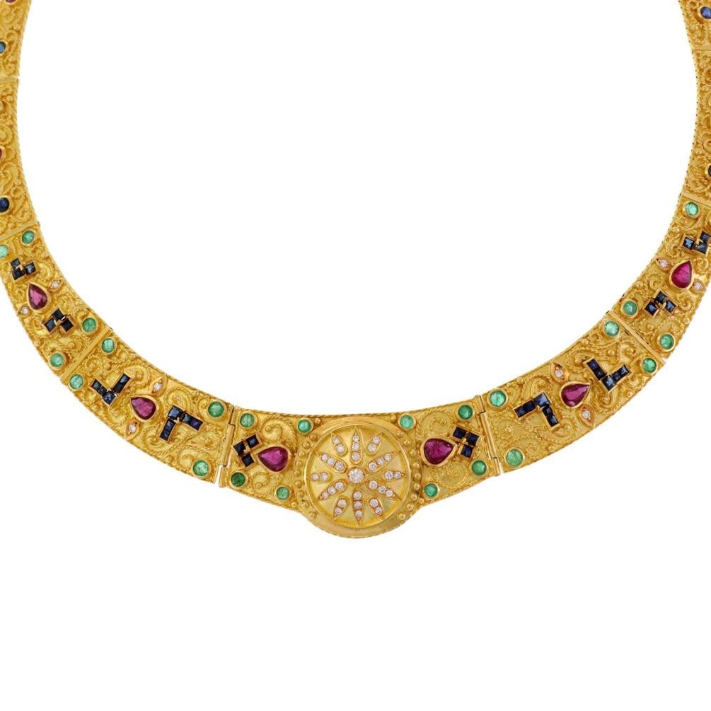 18k Gold Sunburst Graduated Link Necklace with Diamonds and Gemstones: 18k Gold Sunburst Graduated Link Necklace with Diamonds and Gemstones Presenting a stunning graduated link collar necklace, beautifully crafted from 18k yellow gold. The centerpiece features a round m
