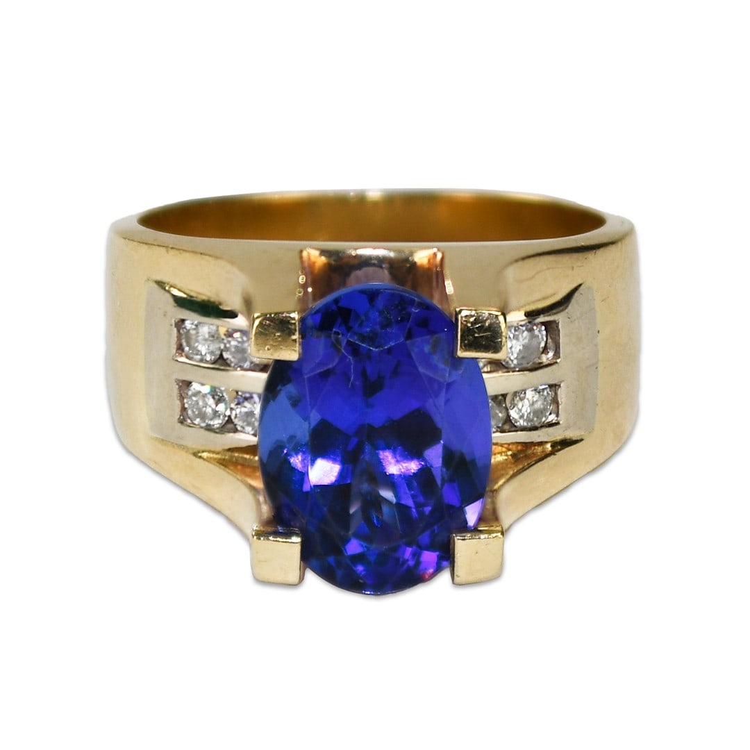 Violet-Blue Tanzanite and Diamond 14k Yellow Gold Cocktail Ring Size 7: Violet-Blue Tanzanite and Diamond 14k Yellow Gold Cocktail Ring Size 7 This cocktail ring features a natural oval-shaped tanzanite, approximately 3.00 carats, set in 14k yellow gold. Accented with rou