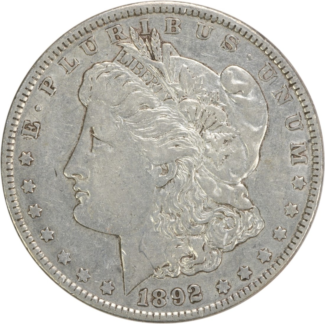 1892 Morgan Silver Dollar EF Uncertified 90% Silver Coin: 1892 Morgan Silver Dollar EF Uncertified 90% Silver Coin This 1892 Morgan Silver Dollar is a classic piece featuring the renowned design by George T. Morgan. With a composition of 90% silver and 10% c