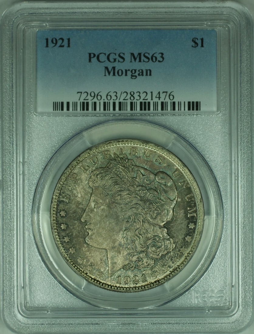 PCGS MS63 1921 Morgan Silver Dollar with Wine in Sand Toning: PCGS MS63 1921 Morgan Silver Dollar with Wine in Sand Toning This 1921 Morgan Silver Dollar is certified by PCGS with a grade of MS-63. Struck at the Philadelphia Mint, the coin features attractive tw