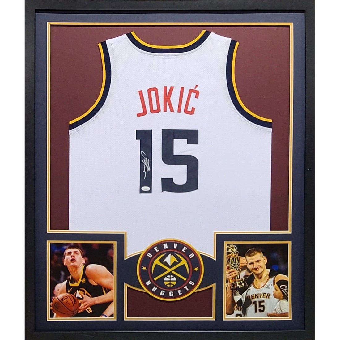 JSA Authenticated Nikola Jokic Signed Denver Nuggets Jersey in Frame: JSA Authenticated Nikola Jokic Signed Denver Nuggets Jersey in Frame This is a framed Denver Nuggets jersey autographed by Nikola Jokic. The jersey has been authenticated by JSA and includes a tamper-