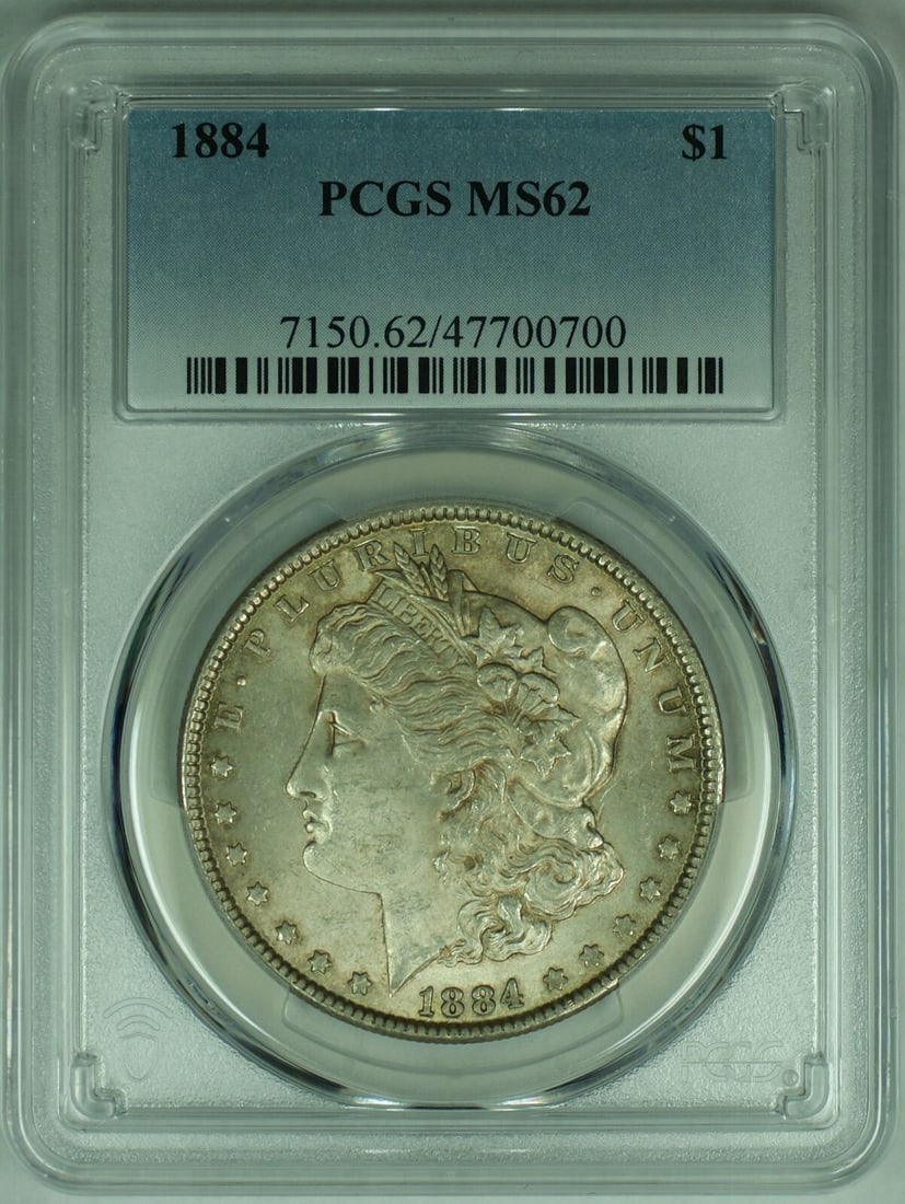 PCGS MS62 1884 Morgan Silver Dollar Toned United States Coin: PCGS MS62 1884 Morgan Silver Dollar Toned United States Coin This 1884 Morgan Silver Dollar is an uncirculated coin graded MS 62 by PCGS. It features a toned finish and is composed of silver. The coin
