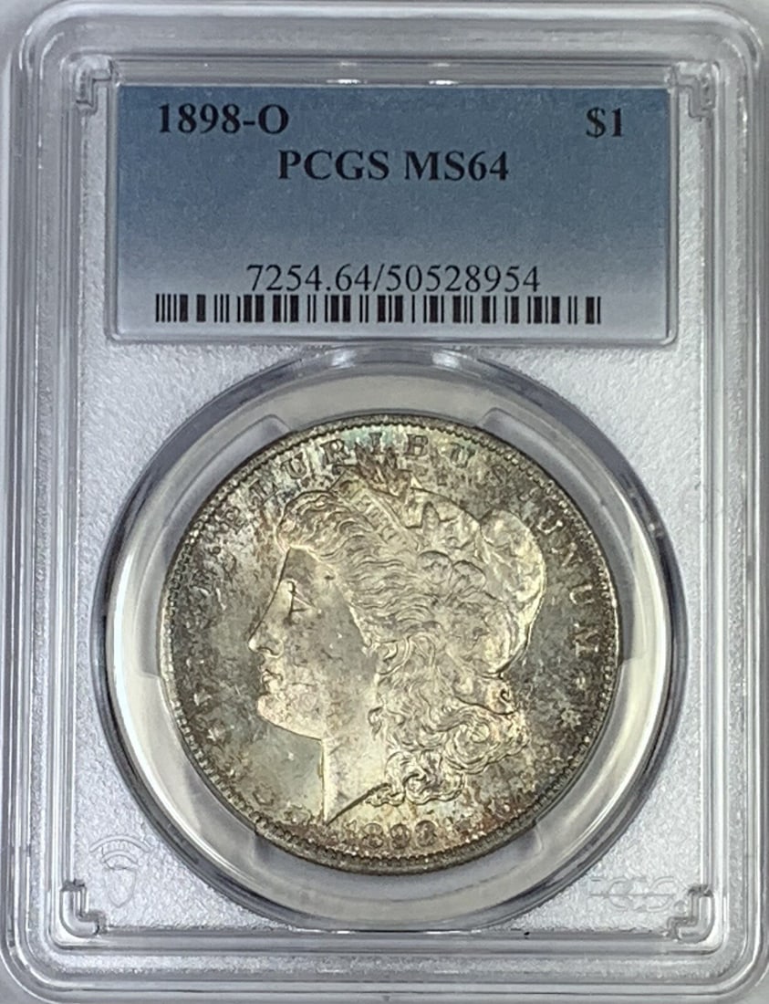 PCGS MS 64 1898-O Silver Morgan Dollar with Toning: PCGS MS 64 1898-O Silver Morgan Dollar with Toning This 1898-O Morgan Silver Dollar features attractive natural toning and has been certified by PCGS with a grade of MS 64. Minted in the United States