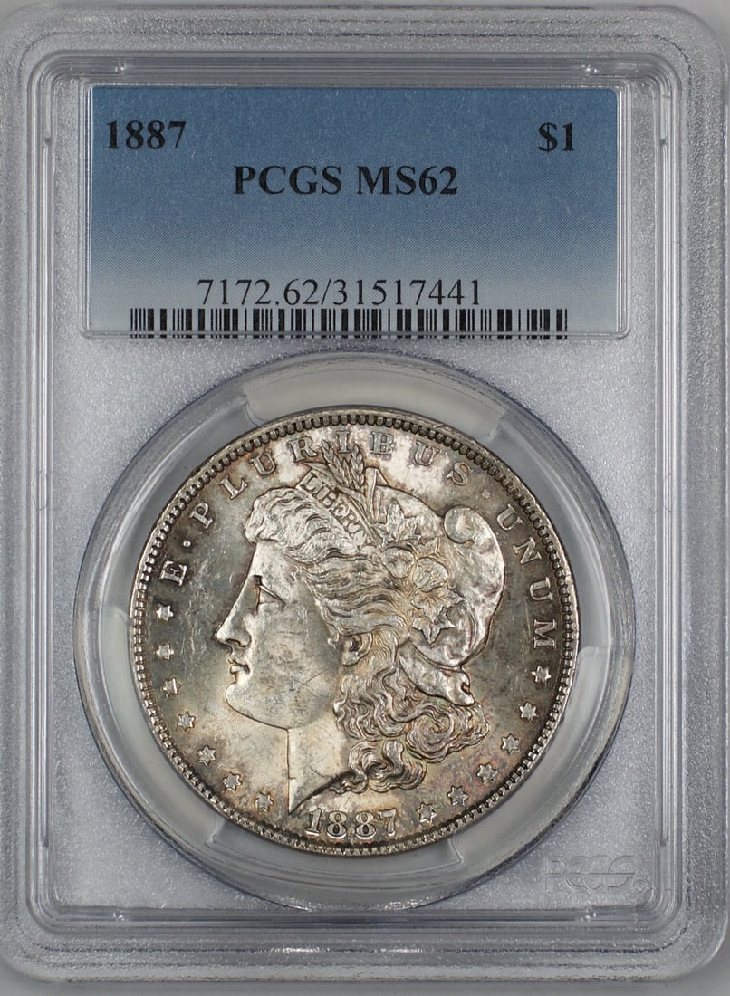 PCGS MS-62 1887 Silver Morgan Dollar With Colorful Reverse Toning: PCGS MS-62 1887 Silver Morgan Dollar With Colorful Reverse Toning This is an 1887 Morgan Silver Dollar graded MS-62 by PCGS, featuring attractive toning, especially on the reverse. The coin was minted