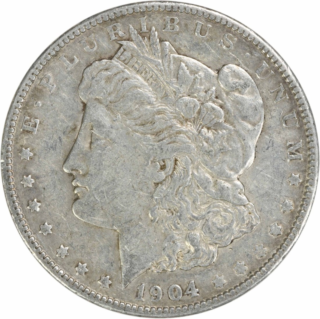 1904 Morgan Silver Dollar EF Uncertified 90% Silver Coin: 1904 Morgan Silver Dollar EF Uncertified 90% Silver Coin This 1904 Morgan Silver Dollar is an exquisite example of American coinage, featuring a design by George T. Morgan. It is circulated and graded