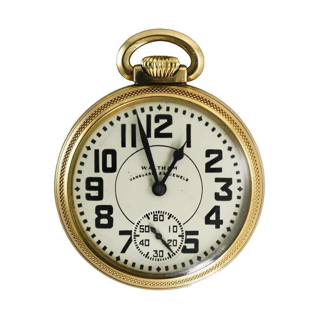 Waltham Vanguard 16 Size 23 Jewel 10K Gold Filled Pocket Watch Circa 1945: Waltham Vanguard 16 Size 23 Jewel 10K Gold Filled Pocket Watch Circa 1945 This Waltham Vanguard pocket watch features a 10k gold-filled open face case with a yellow gold tone and an ivory dial. Manufa