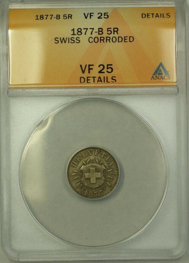Switzerland 1877-B Silver 5 Rappen ANACS VF 25 Details Corroded KM 5: Switzerland 1877-B Silver 5 Rappen ANACS VF 25 Details Corroded KM 5 This 1877-B Switzerland 5 Rappen coin is composed of silver with a 0.05 fineness. Certified by ANACS with a VF 25 grade, the coin i