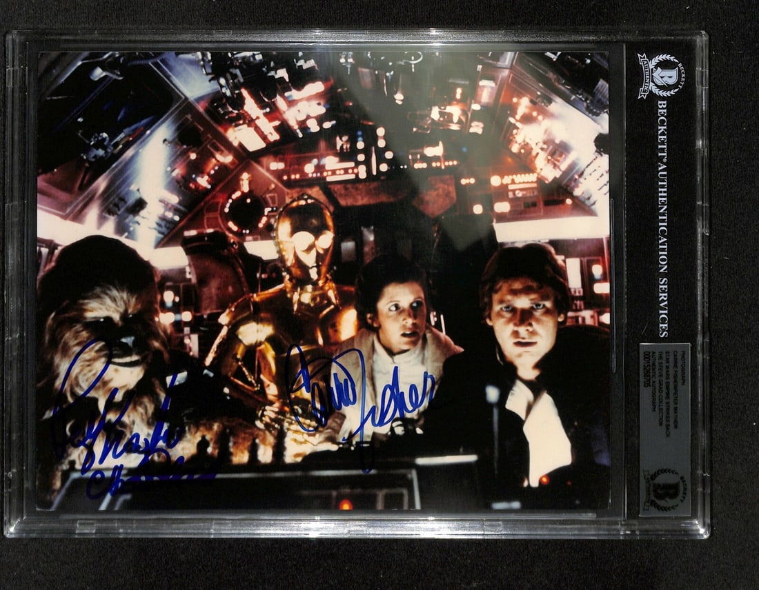 8x10 Photo Signed by Carrie Fisher and Peter Mayhew Beckett Authenticated: 8x10 Photo Signed by Carrie Fisher and Peter Mayhew Beckett Authenticated This is an original 8x10 autographed photograph from Star Wars: The Empire Strikes Back, featuring signatures by Carrie Fisher
