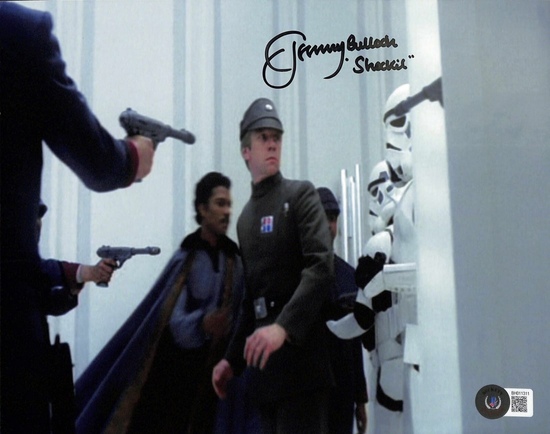 Jeremy Bulloch Signed 8x10 Star Wars Photo with Sheckil Inscription BECKETT: Jeremy Bulloch Signed 8x10 Star Wars Photo with Sheckil Inscription BECKETT This autographed 8x10 photograph features Jeremy Bulloch, best known for his role as Lt. Sheckil in Star Wars: The Empire St