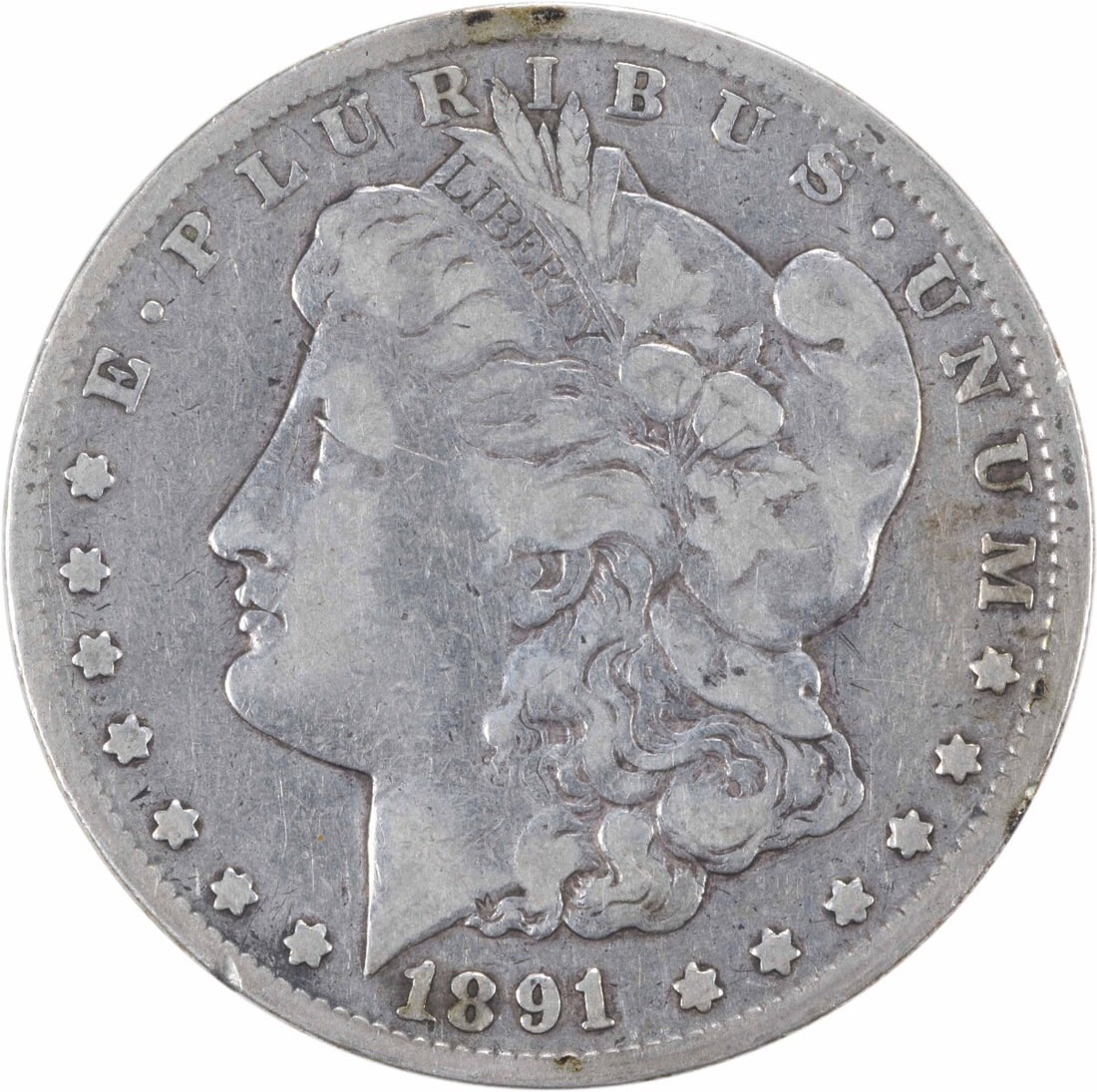 1891-CC Morgan Silver Dollar VF Uncertified 90% Silver Coin: 1891-CC Morgan Silver Dollar VF Uncertified 90% Silver Coin This 1891-CC Morgan Silver Dollar is a remarkable piece from the Carson City mint, showcasing the artistry of designer George T. Morgan. Wit