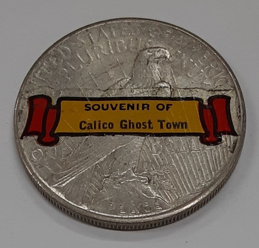 Peace Silver Dollar 1926-S with Calico Ghost Town Sticker Souvenir: Peace Silver Dollar 1926-S with Calico Ghost Town Sticker Souvenir This 1926-S Peace Silver Dollar features a sticker on the reverse, serving as a souvenir from Calico Ghost Town in California. The co
