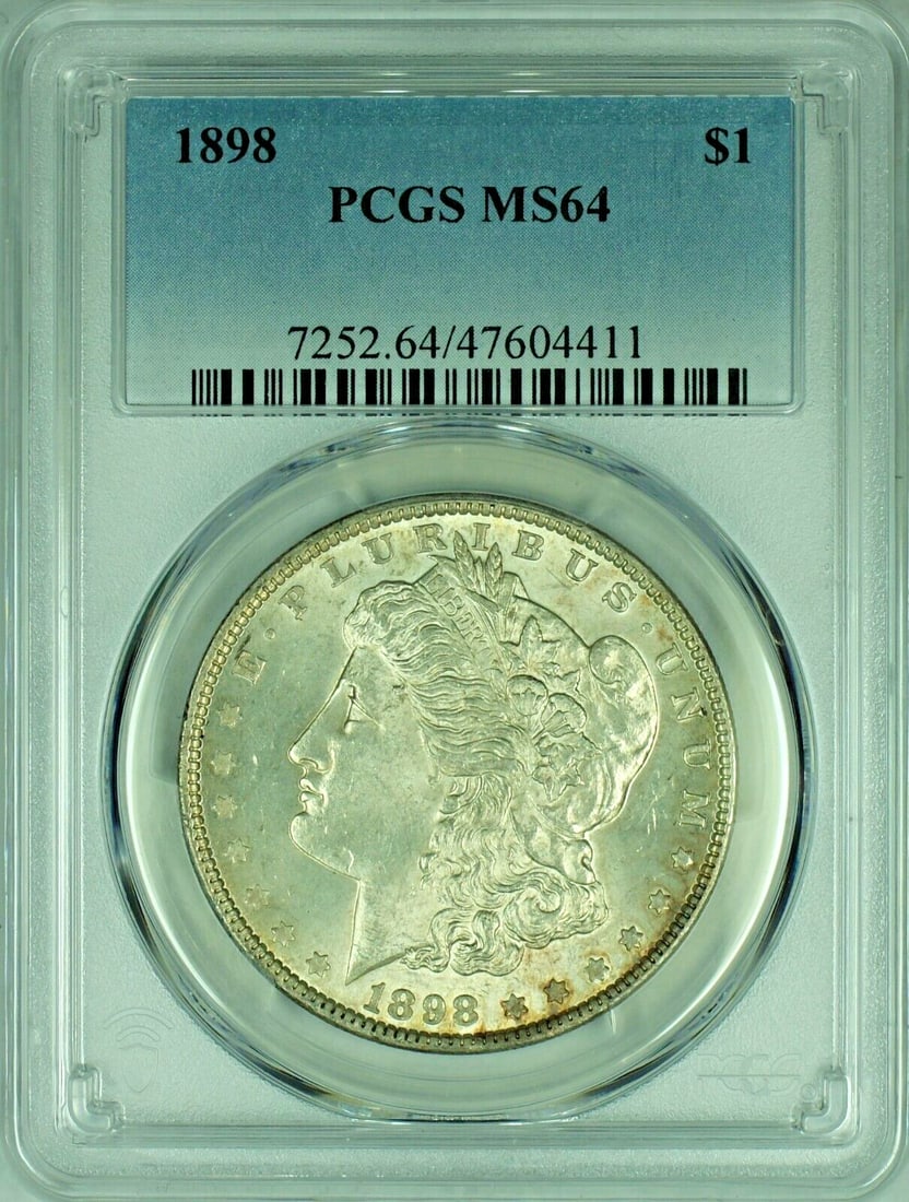 PCGS MS64 1898 Morgan Silver Dollar Certified Uncirculated Coin: PCGS MS64 1898 Morgan Silver Dollar Certified Uncirculated Coin This is an 1898 Morgan Silver Dollar, graded MS 64 by PCGS. The coin is uncirculated and composed of silver. It originates from the Unit