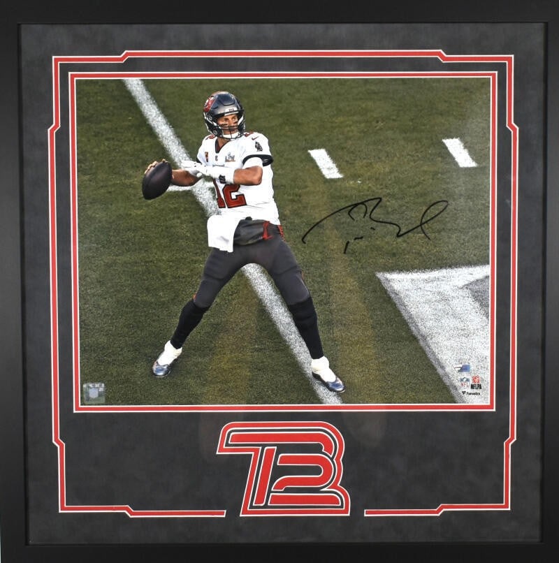 Tom Brady Signed 16x20 Framed Tampa Bay Photo with Fanatics LOA: Tom Brady Signed 16x20 Framed Tampa Bay Photo with Fanatics LOA Capture a moment of sports history with this stunning framed 16X20 photo of Tom Brady in action with the Tampa Bay Buccaneers. This orig