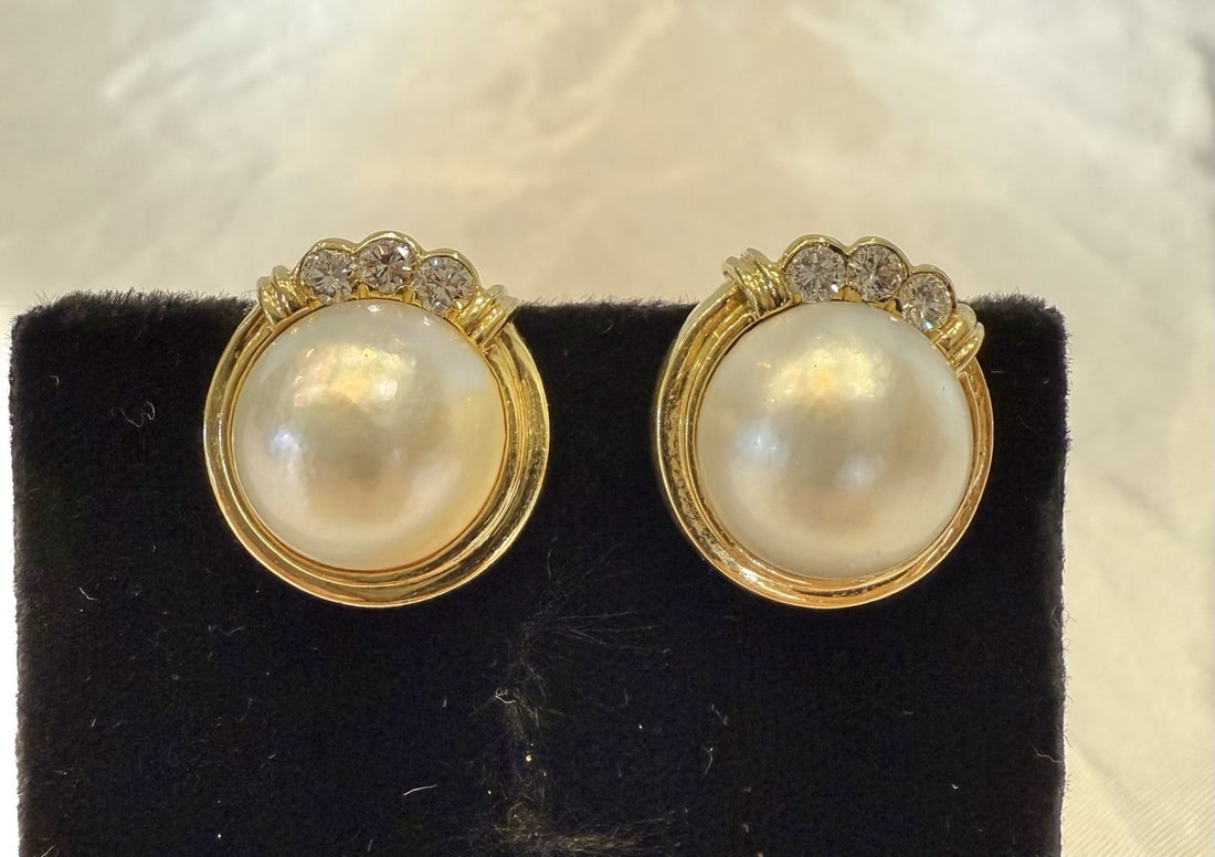 French 18K Gold Diamond Mabe Pearl Clip Earrings: French 18K Gold Diamond Mabe Pearl Clip Earrings This exquisite pair of French earrings showcases the beauty of 18K yellow gold, adorned with stunning diamonds and mabe pearls. Each earring is designe