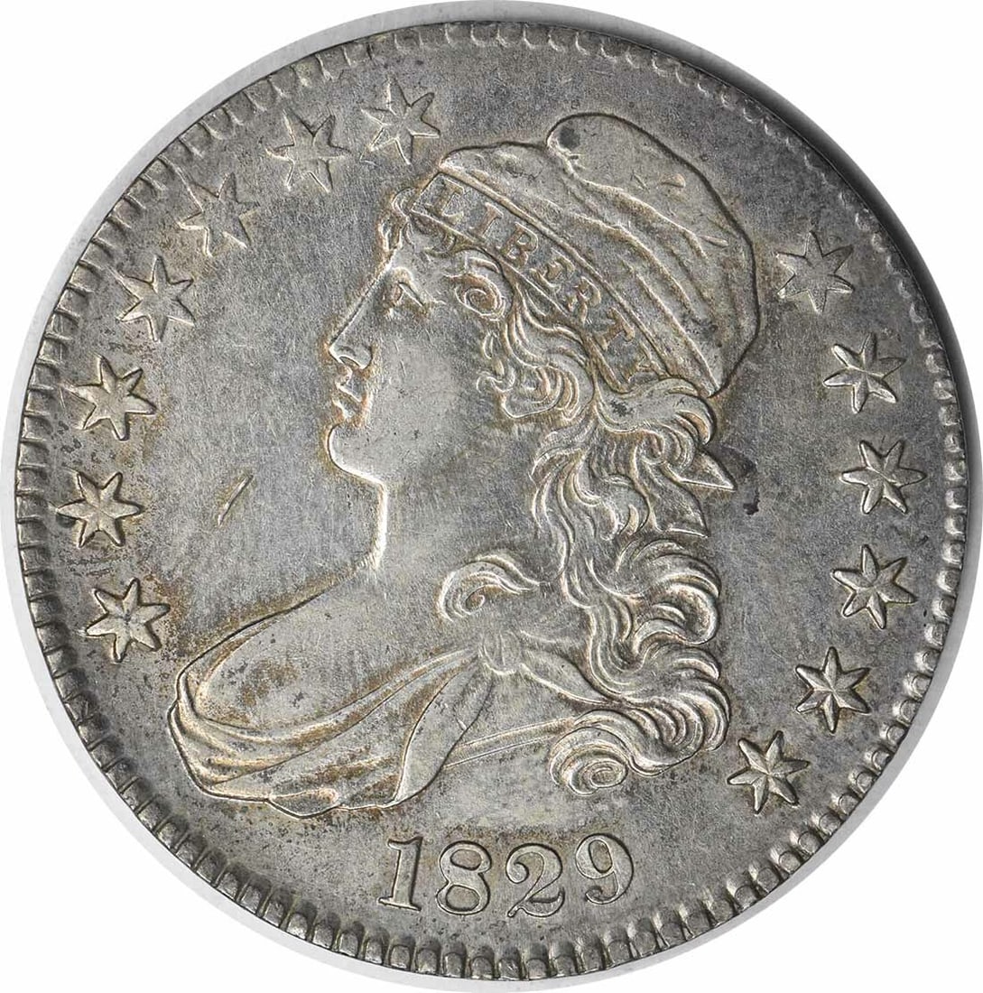 1829 Bust Half Dollar AU John Reich Design Uncertified 50C: 1829 Bust Half Dollar AU John Reich Design Uncertified 50C This 1829 Bust Half Dollar is a notable piece of American numismatic history. Crafted in Philadelphia, this coin features a striking design b