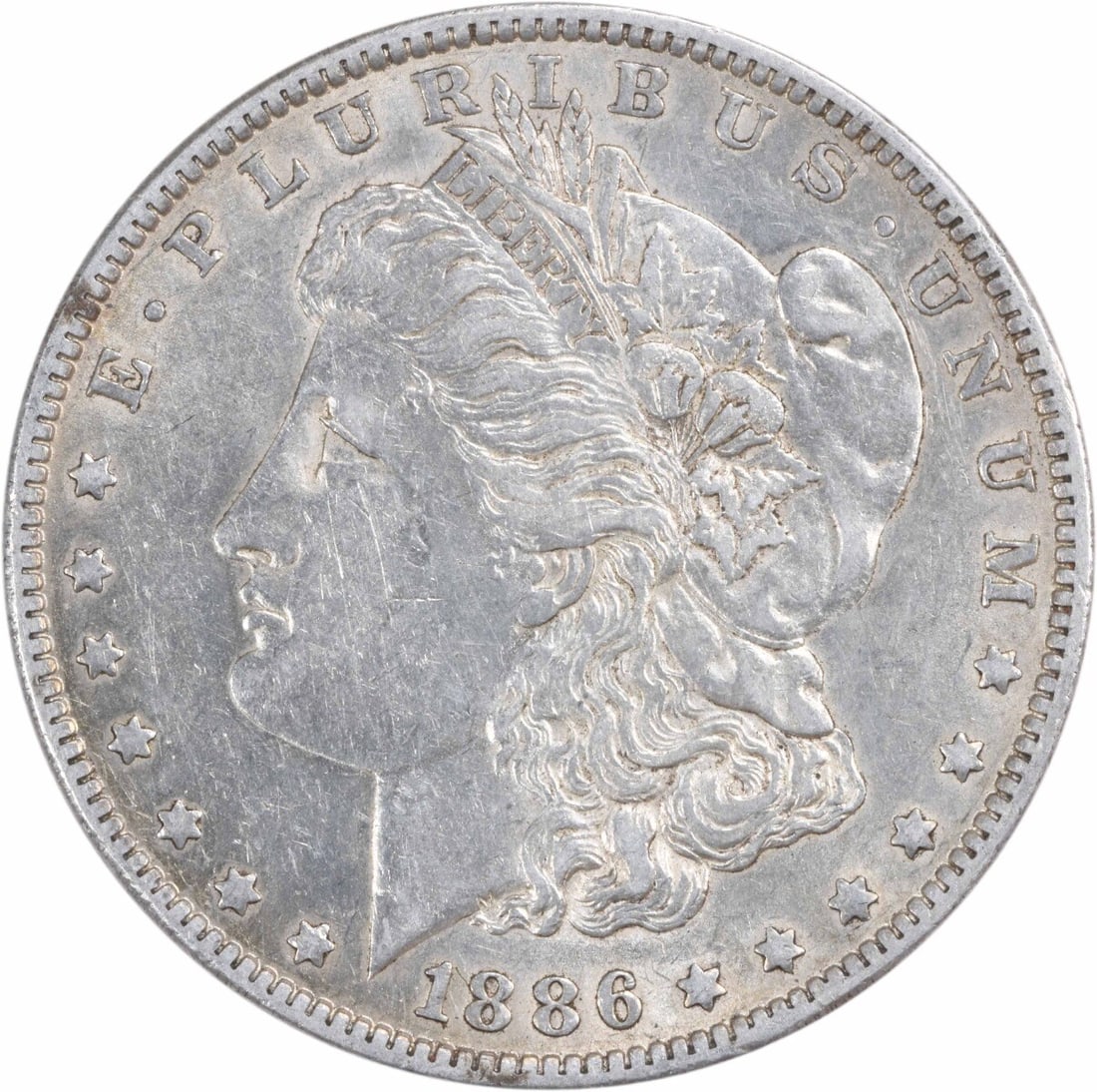 1886-O Morgan Silver Dollar AU Uncertified New Orleans Mint Coin: 1886-O Morgan Silver Dollar AU Uncertified New Orleans Mint Coin This 1886-O Morgan Silver Dollar is a remarkable collectible coin featuring a design by George T. Morgan. Struck in 90% silver and 10%