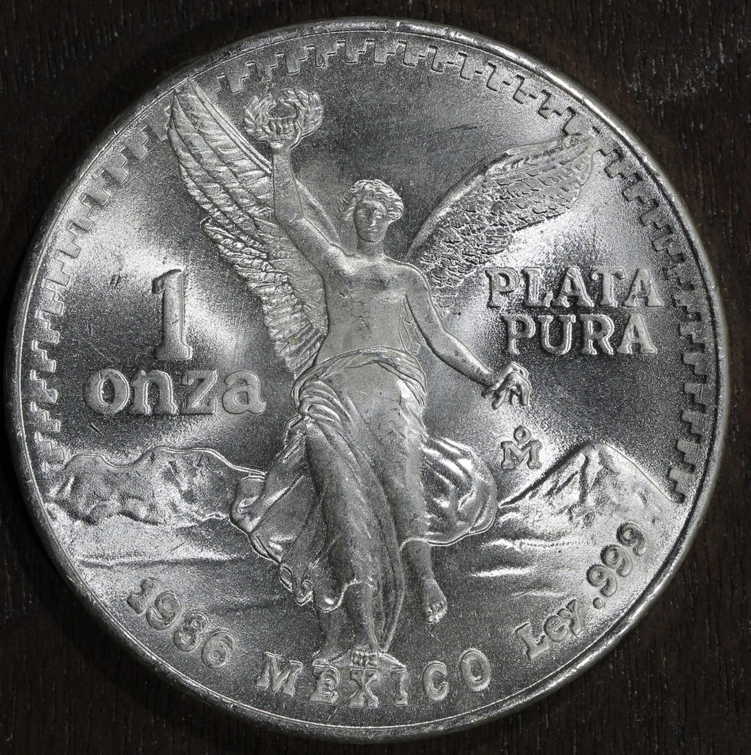 Mexican Libertad 1 oz Silver Coin 1986-Mo .999 Fine Uncertified: Mexican Libertad 1 oz Silver Coin 1986-Mo .999 Fine Uncertified This is a 1986-Mo Mexico 1 oz Silver Libertad Onza coin, featuring a composition of .999 fine silver. Minted by the Mexican Mint, this c