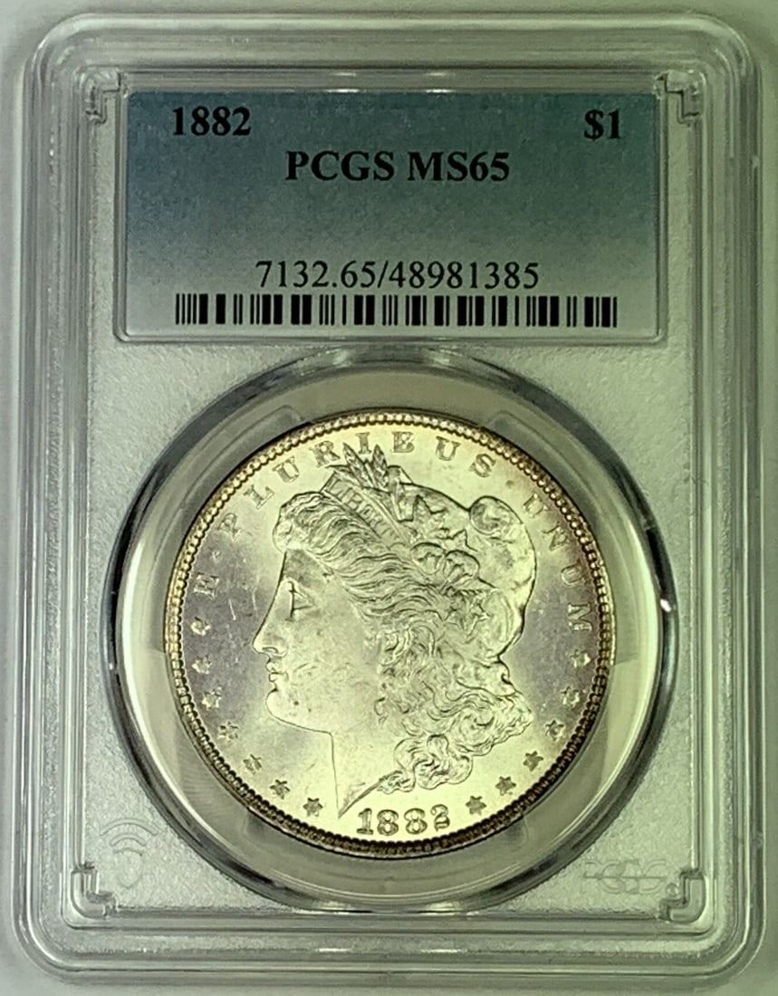 PCGS MS 65 1882 Morgan Silver Dollar Coin Certified: PCGS MS 65 1882 Morgan Silver Dollar Coin Certified This 1882 Morgan Silver Dollar is graded MS 65 by PCGS and remains in uncirculated condition. Composed of silver, this coin was minted in the United