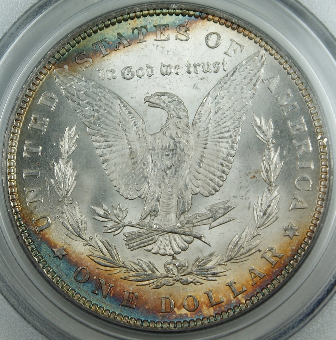 PCGS MS-64 1882 Morgan Dollar Silver Coin With Edge Toning: PCGS MS-64 1882 Morgan Dollar Silver Coin With Edge Toning This 1882 Morgan Silver Dollar is certified by PCGS with a grade of MS-64, indicating an uncirculated condition. Struck at the Philadelphia M