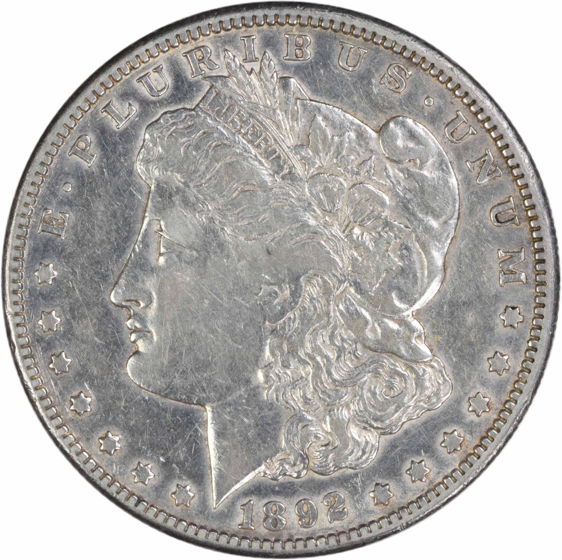 Carson City 1892 Morgan Dollar 90 Percent Silver VF Grade Uncertified: Carson City 1892 Morgan Dollar 90 Percent Silver VF Grade Uncertified This 1892-CC Morgan Silver Dollar is a circulated coin graded Very Fine (VF). Struck at the Carson City Mint, it features a compos