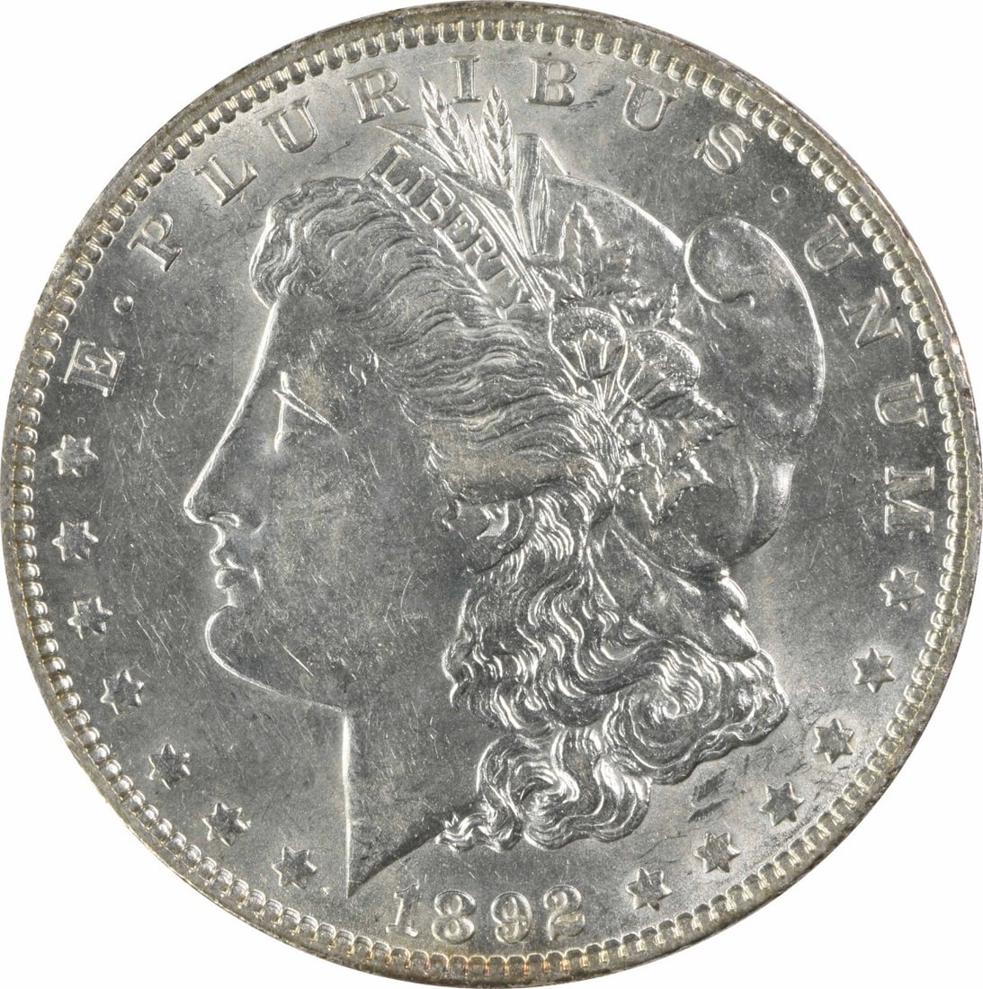 1892 Morgan Silver Dollar AU Uncertified George T. Morgan Design: 1892 Morgan Silver Dollar AU Uncertified George T. Morgan Design This 1892 Morgan Silver Dollar is an attractive piece for collectors, showcasing the artistry of designer George T. Morgan. With a grad