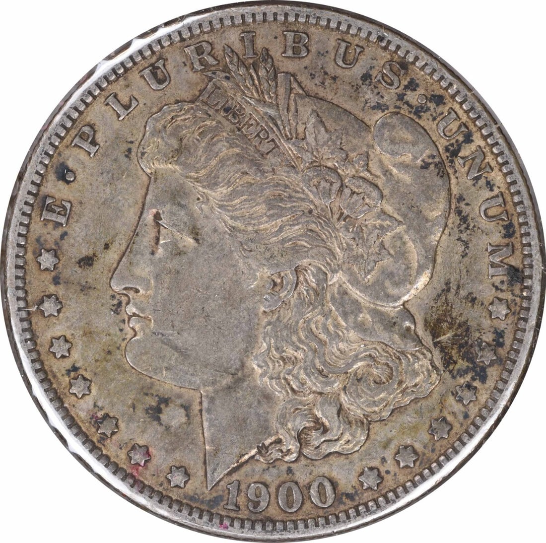 1900-O Morgan Silver Dollar XF Uncertified 90% Silver Coin: 1900-O Morgan Silver Dollar XF Uncertified 90% Silver Coin This 1900-O/CC Morgan Silver Dollar is a remarkable piece featuring a classic design by George T. Morgan. Made of 90% silver and 10% copper,