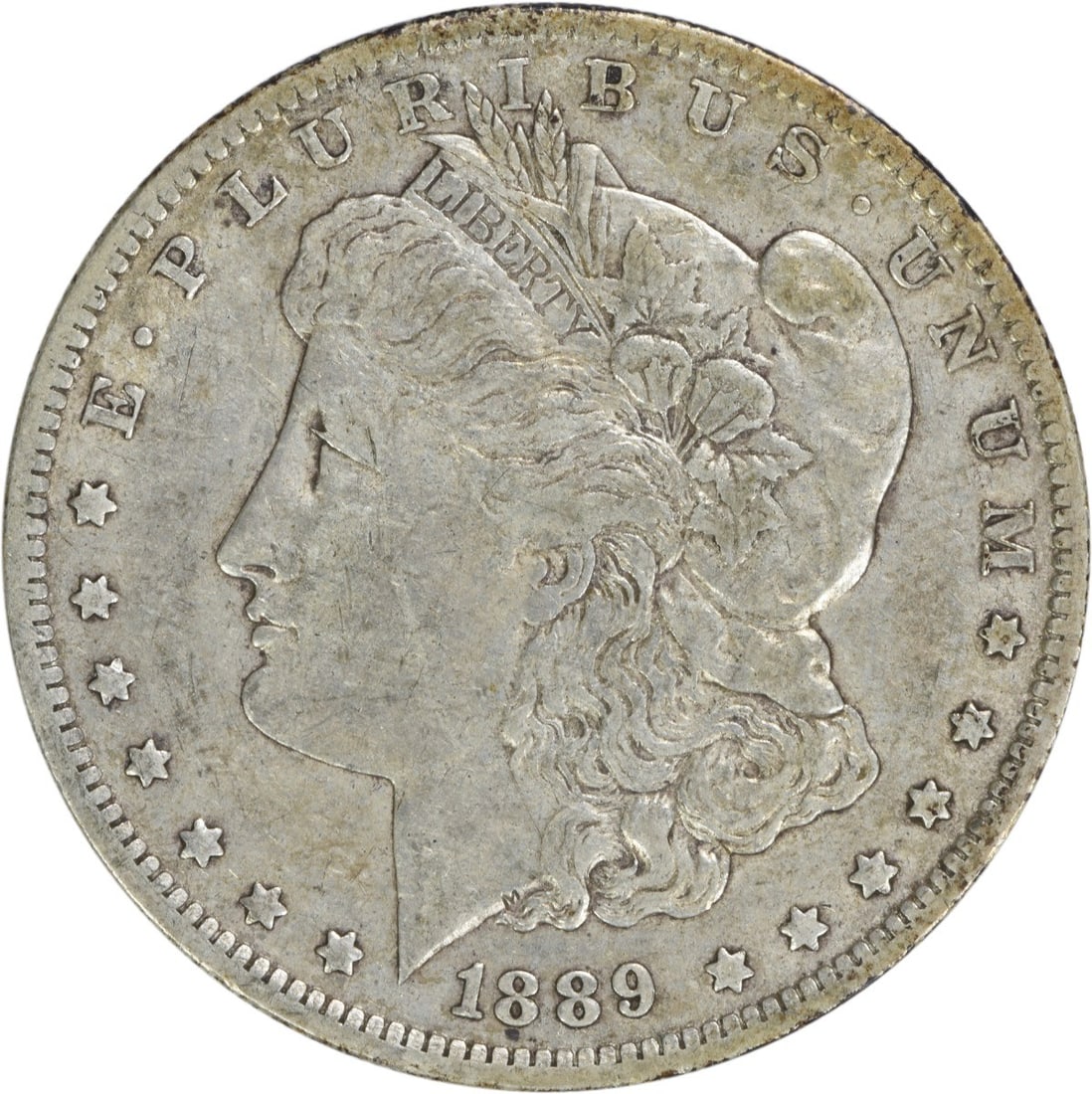 1889-O Morgan Silver Dollar EF Uncertified 90% Silver Coin: 1889-O Morgan Silver Dollar EF Uncertified 90% Silver Coin This 1889-O Morgan Silver Dollar is a remarkable piece of numismatic history, featuring a design by George T. Morgan. The coin is composed of