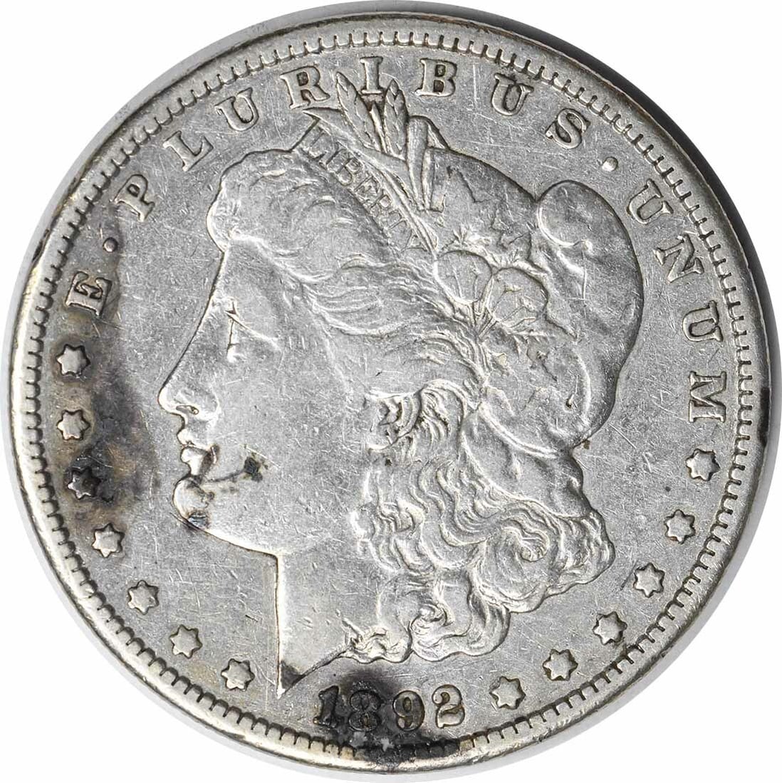 1892-CC Morgan Silver Dollar VF Uncertified 90% Silver Coin: 1892-CC Morgan Silver Dollar VF Uncertified 90% Silver Coin This 1892-CC Morgan Silver Dollar is a remarkable piece of numismatic history. Featuring the iconic design by George T. Morgan, this coin is