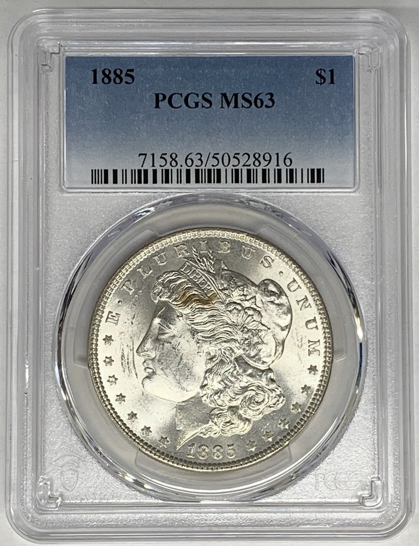 1885 Morgan Dollar Silver Coin Graded MS 63 by PCGS: 1885 Morgan Dollar Silver Coin Graded MS 63 by PCGS This 1885 Morgan Silver Dollar is graded MS 63 by PCGS. Produced in the United States, this uncirculated coin features a denomination of $1 and is c