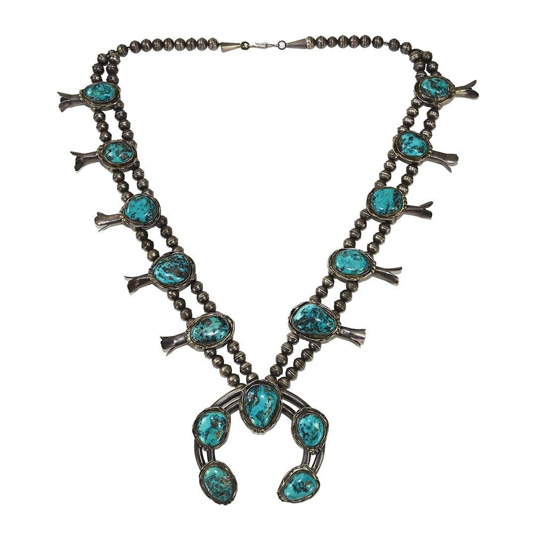 Sterling Silver Turquoise Squash Blossom Necklace 24 Inch Length: Sterling Silver Turquoise Squash Blossom Necklace 24 Inch Length This Native American squash blossom necklace features sterling silver beads and turquoise stones in a classic design. The necklace is u