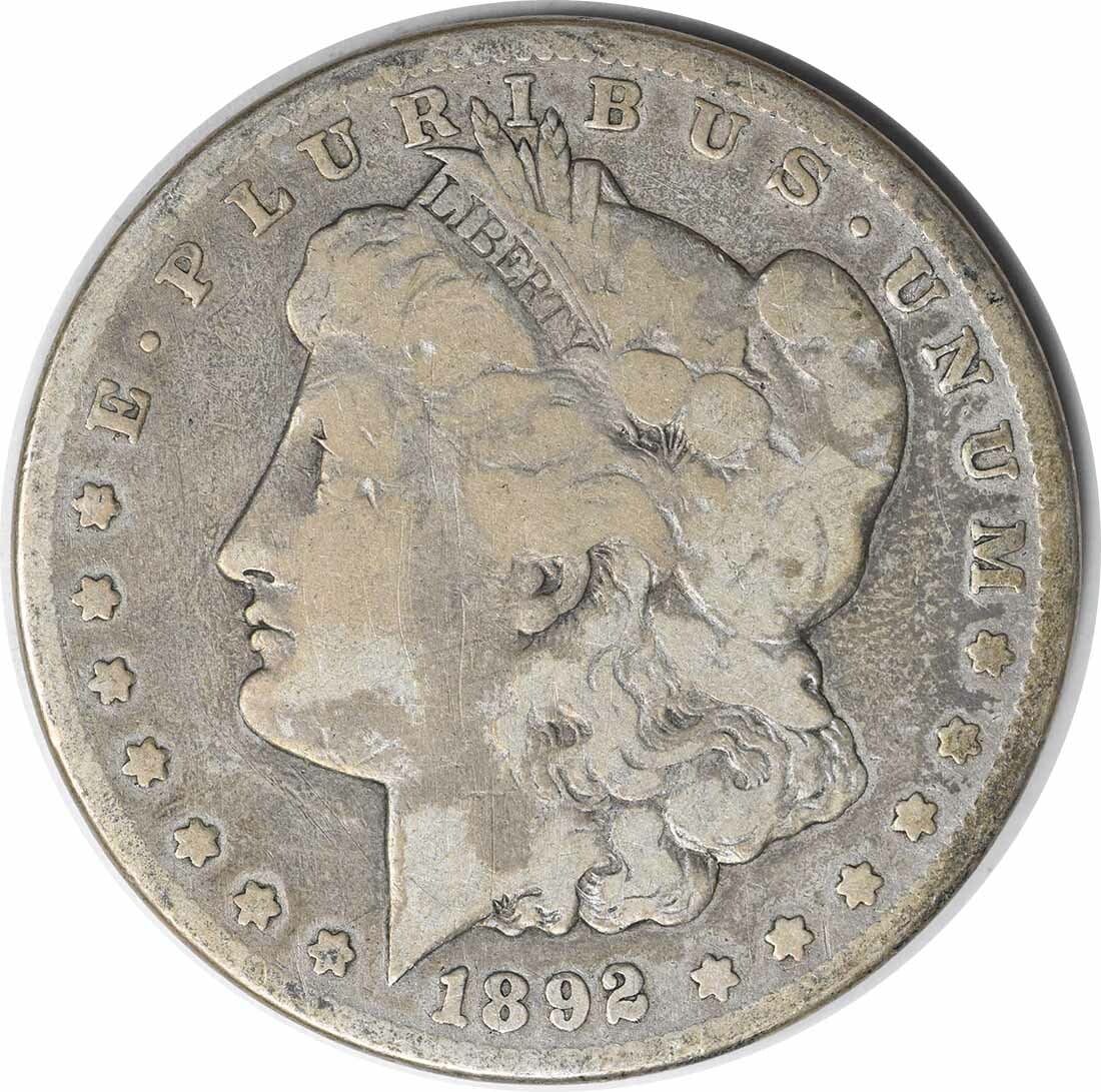 Carson City 1892 CC Morgan Dollar 90 Percent Silver VG Grade Uncertified: Carson City 1892 CC Morgan Dollar 90 Percent Silver VG Grade Uncertified This is an 1892-CC Morgan Silver Dollar, featuring 90% silver and 10% copper composition. Minted in Carson City, this circulate