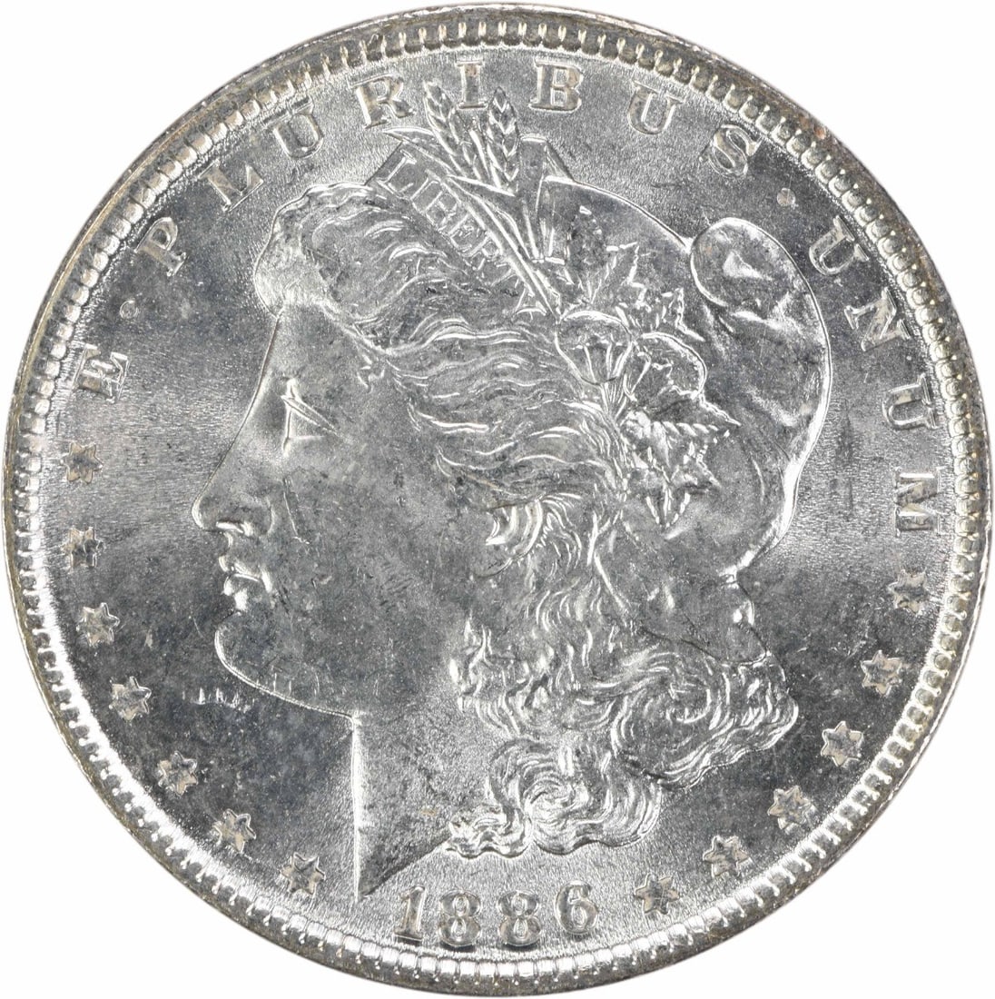 1886 Morgan Silver Dollar Uncertified Brilliant Uncirculated: 1886 Morgan Silver Dollar Uncertified Brilliant Uncirculated This 1886 Morgan Silver Dollar is an uncirculated coin, graded as Brilliant Uncirculated (BU). The coin features a silver composition and w