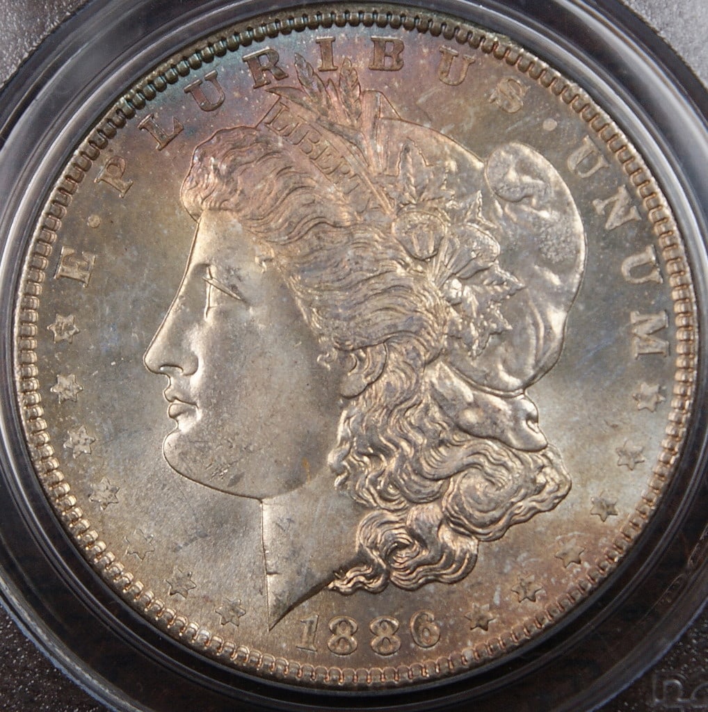 PCGS MS-65 1886 Morgan Dollar Silver Coin With Toning: PCGS MS-65 1886 Morgan Dollar Silver Coin With Toning This 1886 Morgan Silver Dollar features a beautiful blue and purple toning above Liberty's head, adding to its visual appeal. Graded MS-65 by PCGS