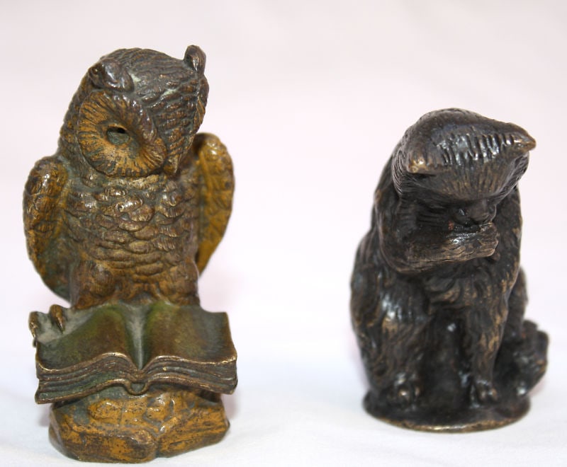 19th Century Austrian Bronze Owl and Cat Figurines Set: 19th Century Austrian Bronze Owl and Cat Figurines Set This exquisite two-piece collection features 19th century Austrian bronze figurines of an owl and a cat. The owl, depicted reading a book, stands