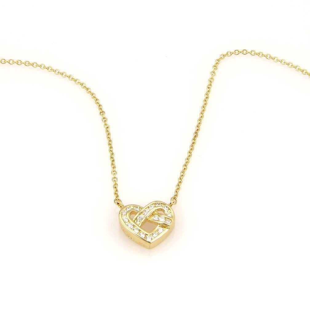 Tiffany & Co. 18K Yellow Gold Heart Knot Pendant Necklace with Diamonds: Tiffany & Co. 18K Yellow Gold Heart Knot Pendant Necklace with Diamonds This exquisite necklace from Tiffany & Co. features a stunning heart knot pendant crafted in 18K yellow gold. Adorned with spark