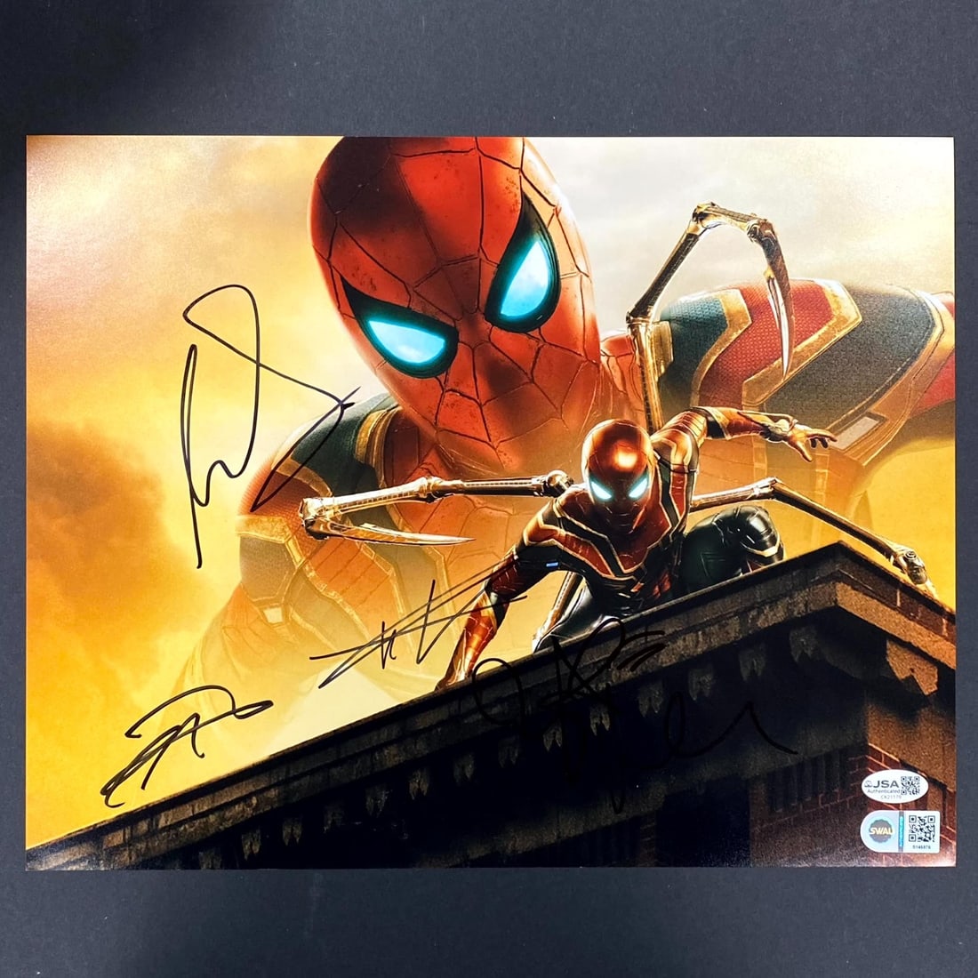 11x14 Spider-Man Photo Signed by Tom Holland Zendaya Tomei Revolori JSA Authenticated: 11x14 Spider-Man Photo Signed by Tom Holland Zendaya Tomei Revolori JSA Authenticated This original 11x14 photograph from the movie Spider-Man is signed by Tom Holland. The autograph has been authenti