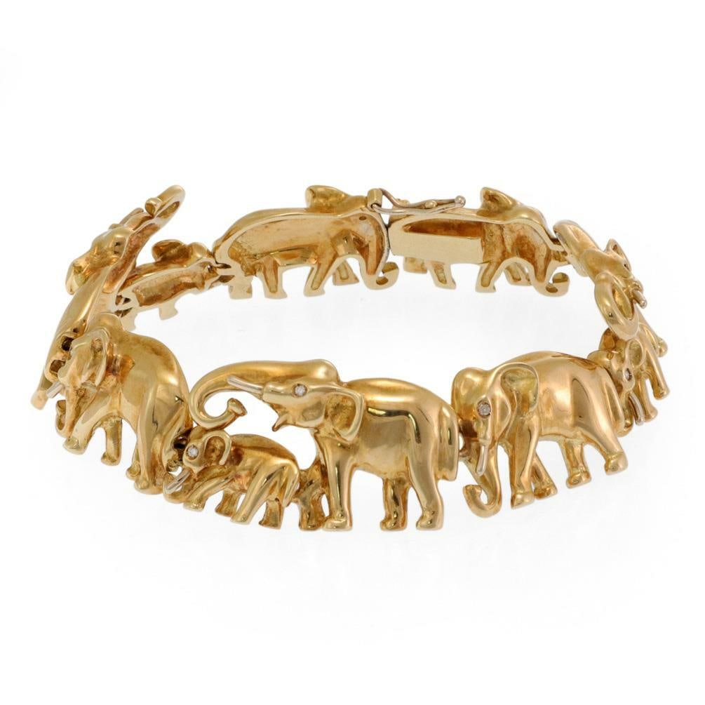 Charming 18k Yellow Gold Elephant Link Bracelet with Diamond Eyes: Charming 18k Yellow Gold Elephant Link Bracelet with Diamond Eyes This charming Elephant Link Bracelet is expertly crafted from 18k yellow gold, showcasing a polished finish. The bracelet features a d