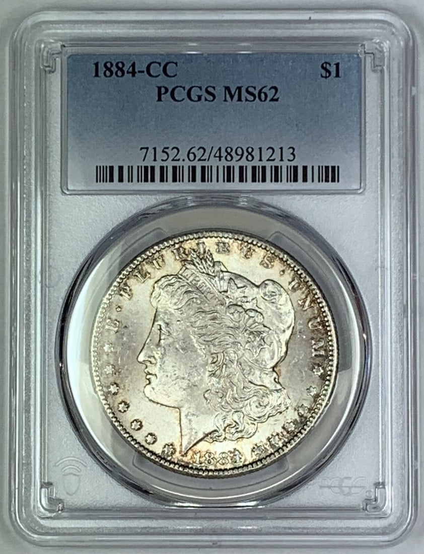PCGS MS 62 1884 Carson City Morgan Silver Dollar Toned: PCGS MS 62 1884 Carson City Morgan Silver Dollar Toned This 1884-CC Morgan Silver Dollar is a certified uncirculated coin, graded MS 62 by PCGS. Minted in Carson City, it features attractive toning an