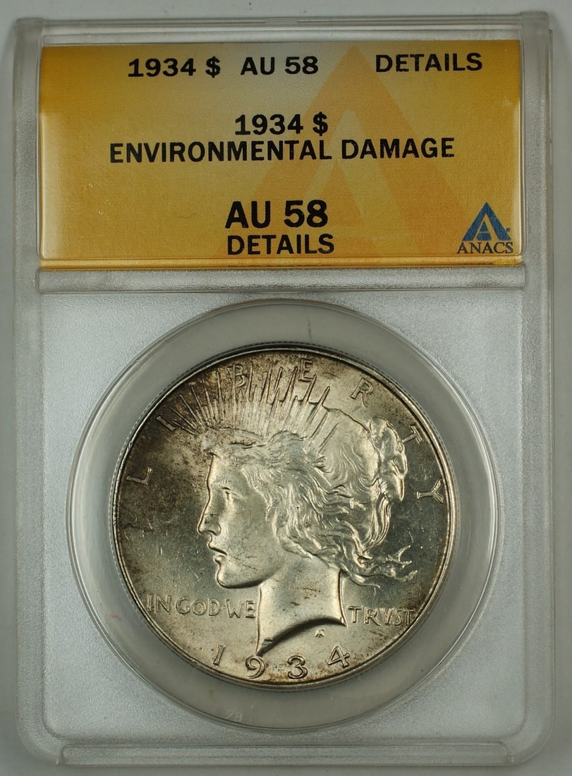 1934 Philadelphia Silver Peace Dollar AU-58 Details ANACS Environmental Damage: 1934 Philadelphia Silver Peace Dollar AU-58 Details ANACS Environmental Damage This 1934 Silver Peace Dollar is graded AU-58 Details by ANACS and was minted in Philadelphia. The coin is made of silver