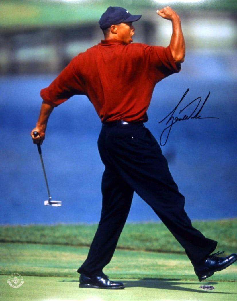 Tiger Woods Autographed 16x20 Photo Fist Pump Upper Deck: Tiger Woods Autographed 16x20 Photo Fist Pump Upper Deck Celebrate the legacy of golf with this iconic 16X20 photograph of Tiger Woods captured in his famous 'fist pump' moment. This original autograp