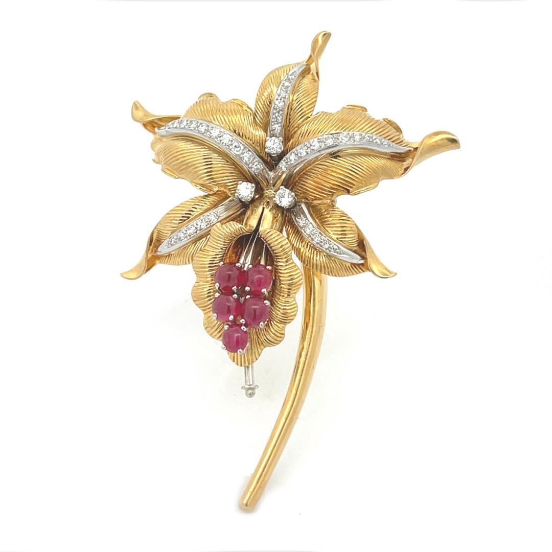 Spritzer & Furman 18k Gold Diamond Ruby Flower Brooch Pin: Spritzer & Furman 18k Gold Diamond Ruby Flower Brooch Pin This exquisite brooch by Spritzer & Furman showcases a classic floral design crafted in 18k yellow gold. The piece features large leaf-shaped