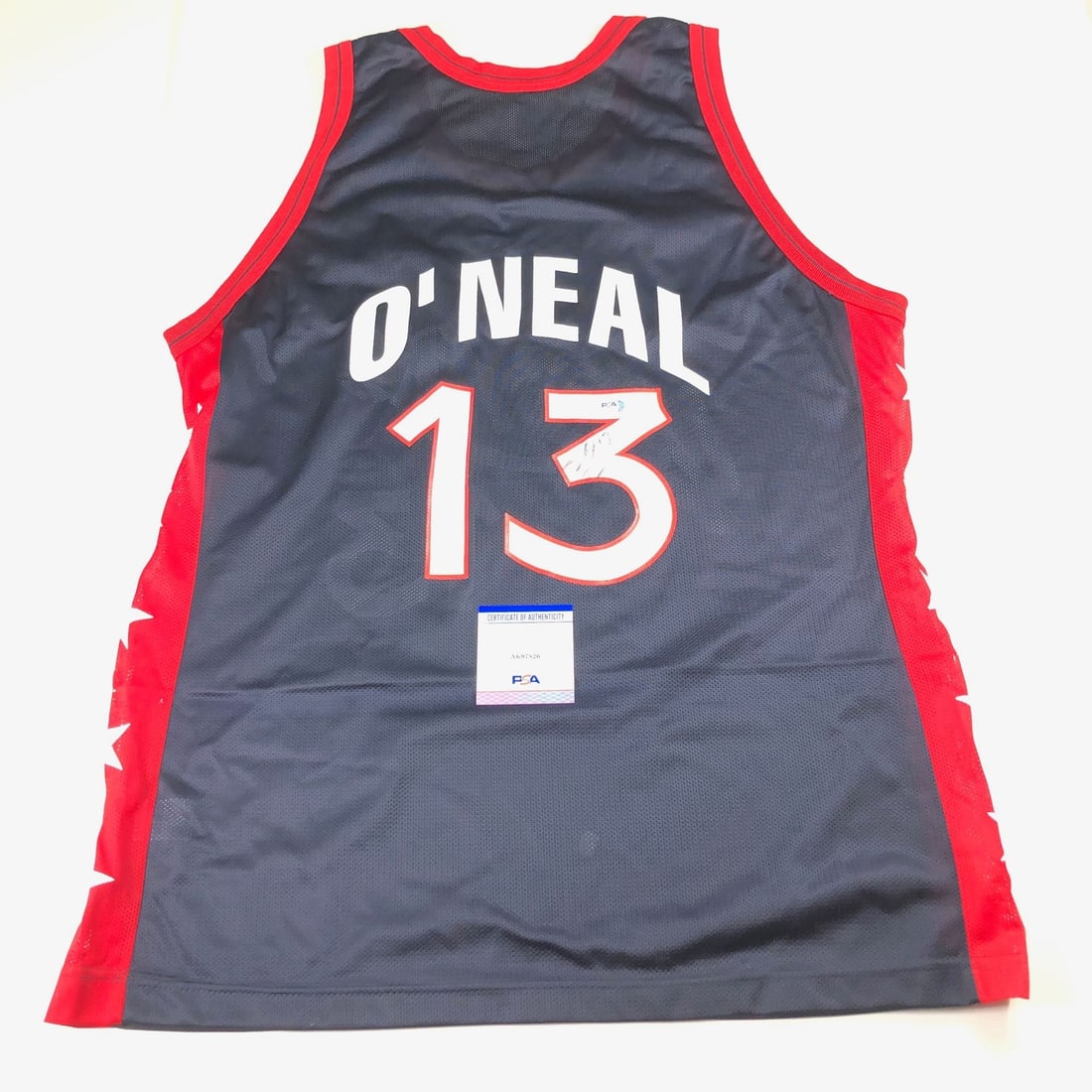 Shaquille O'Neal Team USA Jersey Autographed PSA/DNA Certified: Shaquille O'Neal Team USA Jersey Autographed PSA/DNA Certified This authentic Team USA jersey is autographed by the legendary Shaquille O'Neal, known for his remarkable career in the NBA, particularly