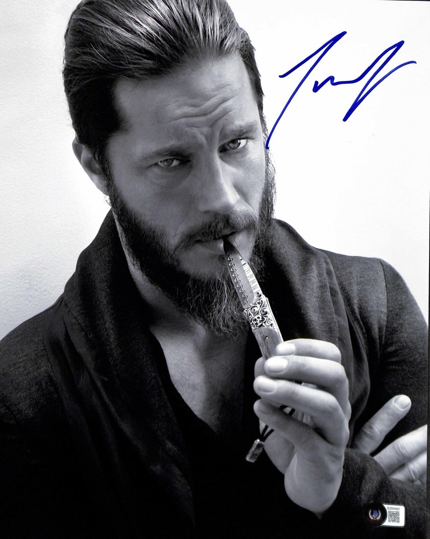 Travis Fimmel Autographed Vikings Ragnar 11x14 Photo Beckett Certified: Travis Fimmel Autographed Vikings Ragnar 11x14 Photo Beckett Certified This 11x14 photograph features the signature of Travis Fimmel, known for his role as "Ragnar" in the TV series Vikings. Signed in