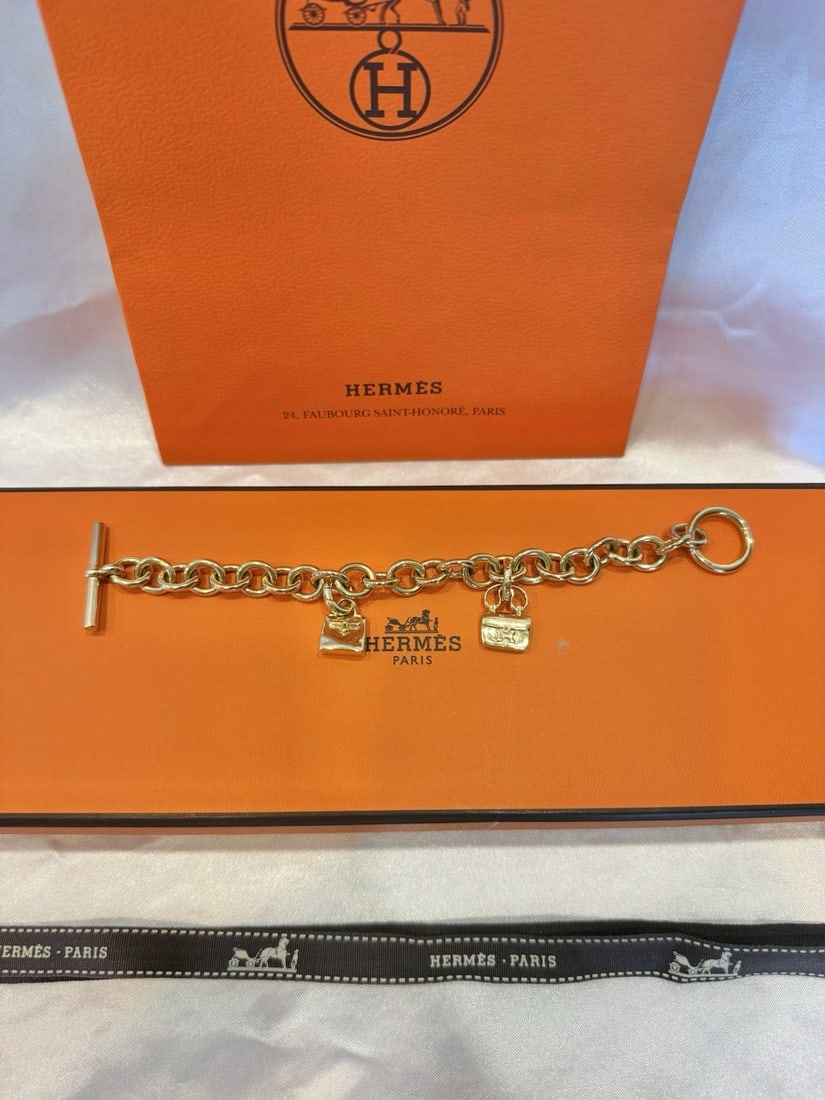 HERMES 18K Yellow Gold Charm Bracelet with Box: HERMES 18K Yellow Gold Charm Bracelet with Box This exquisite Hermes bracelet is crafted from 18K yellow gold, showcasing exceptional detail, design, and craftsmanship. The charm-style bracelet is ful