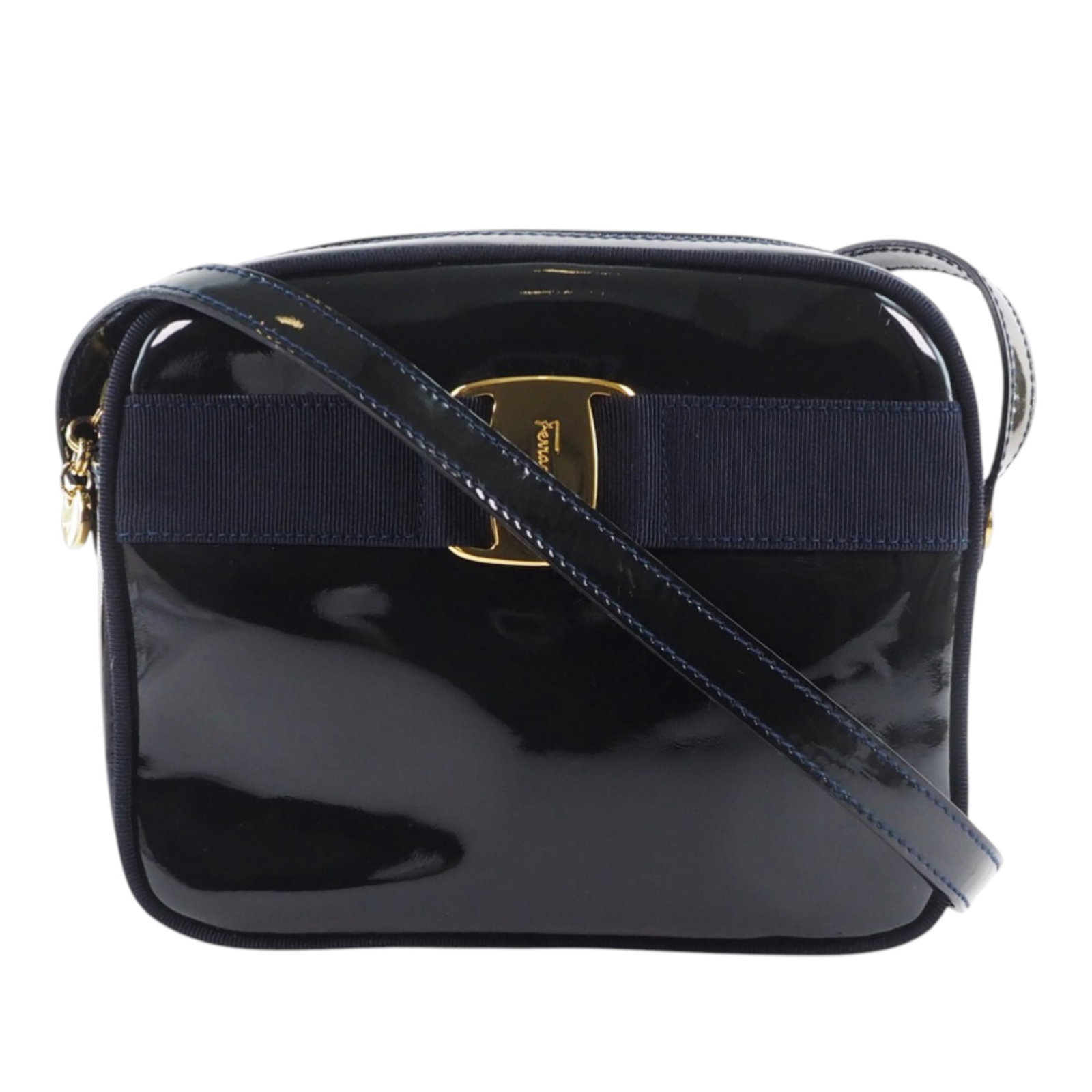 Blue Patent Leather Vara Crossbody Bag with Canvas Trim by Ferragamo: Blue Patent Leather Vara Crossbody Bag with Canvas Trim by Ferragamo This Ferragamo Patent Vara Crossbody bag is crafted from patent leather with canvas trim and features a flat leather strap, a top z
