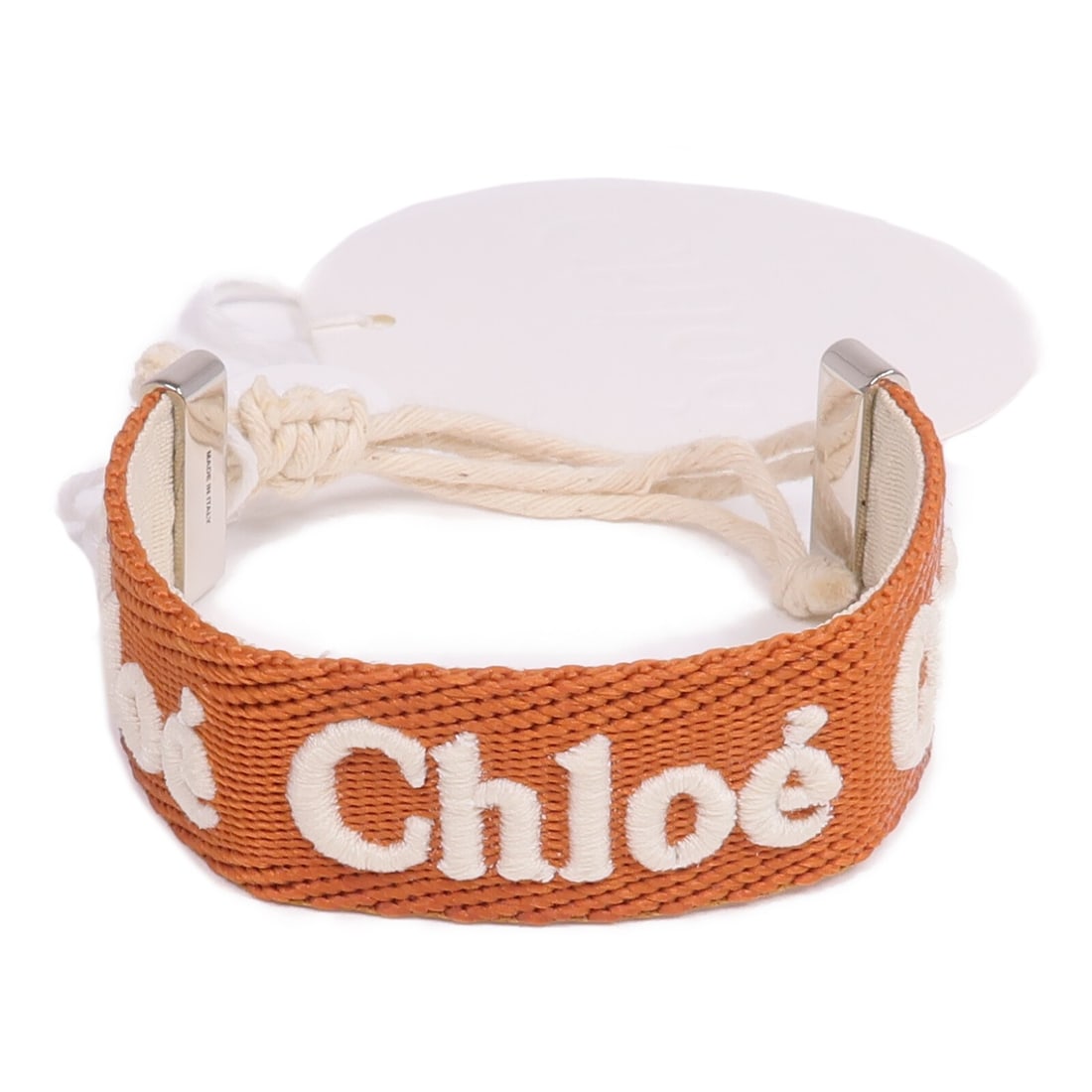 Chloe Woody Brown Fabric Bangle Bracelet with Silver Tone Hardware: Chloe Woody Brown Fabric Bangle Bracelet with Silver Tone Hardware This Chloe Woody bangle is crafted from brown fabric, offering a distinctive and stylish accessory. Designed in a regular size, it fe